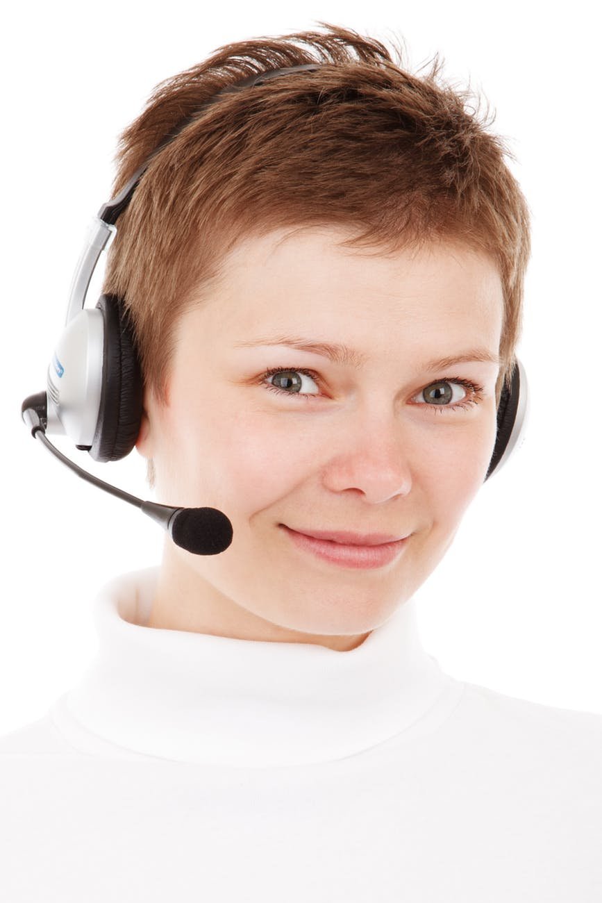 person wearing silver headset smiling